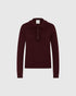 Burgundy long-sleeved polo sweater with ruffles along the collar and button placket, front view.