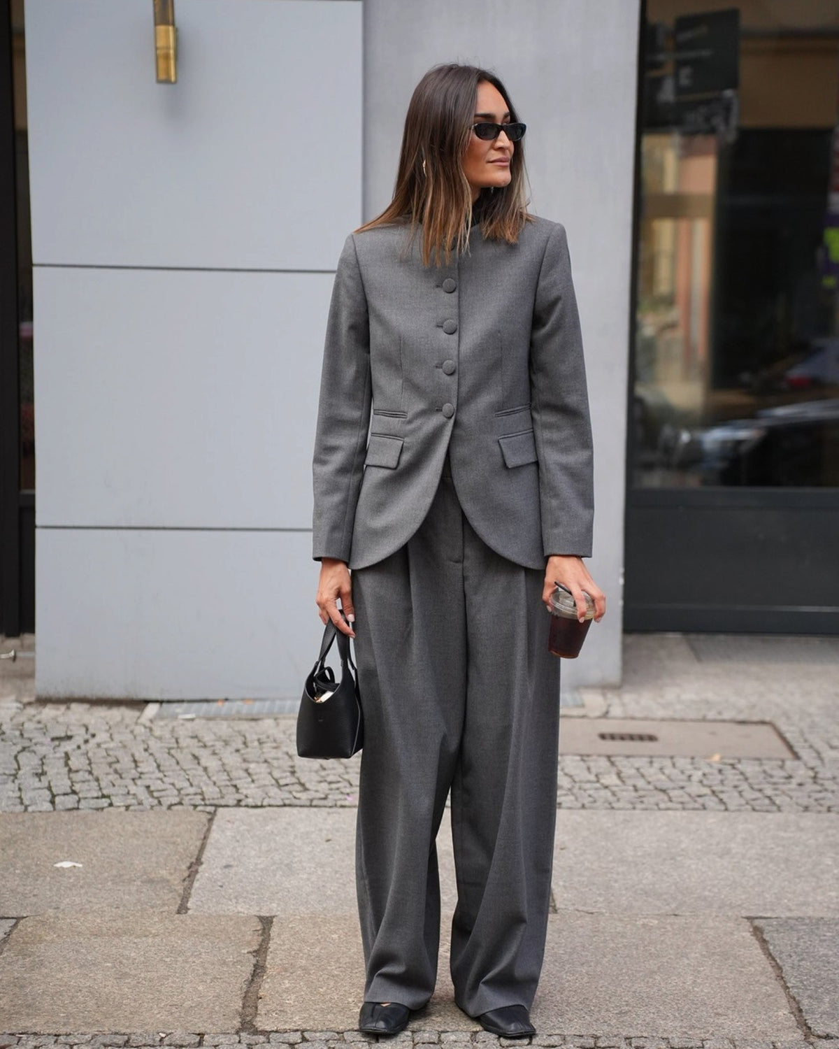 Dark grey By Malene Birger barrel-leg pants on a model with a matching blazer, full-length front view.