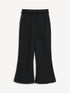 Black cropped bouclé pants, front view with slightly flared legs and fringed hems.