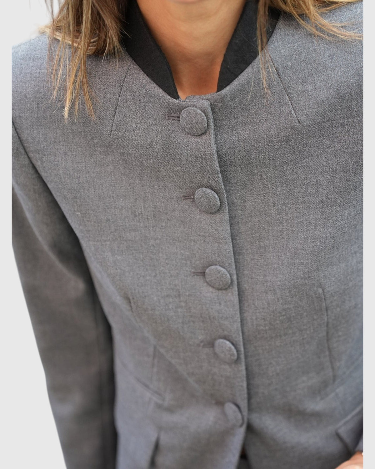 Dark grey Claye blazer by By Malene Birger on a model, close-up of the buttons and neckline.