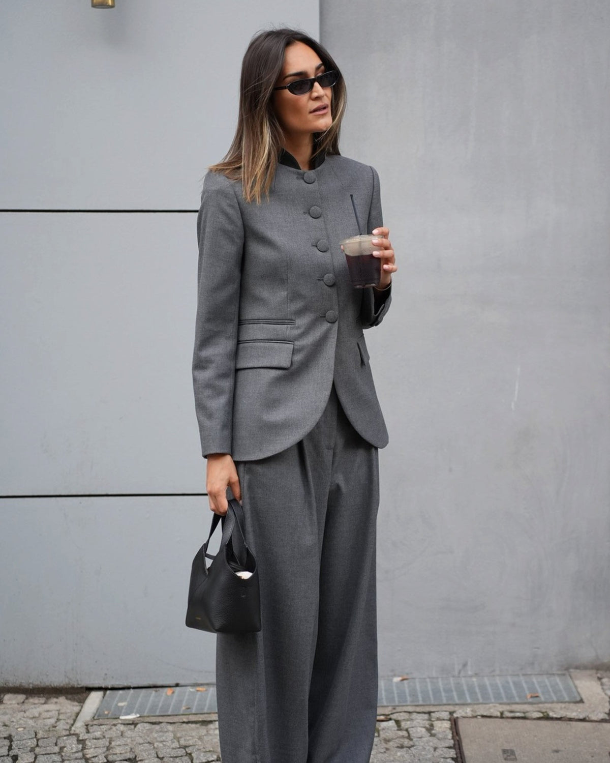 Dark grey Claye blazer by By Malene Birger on a model with matching pants, front view.