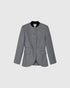 Dark grey Claye blazer, front view with a stand collar, covered buttons, flap pockets and a curved hem.