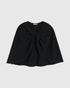 Black wool-blend cape, front view with a central knot and softly draped panels.