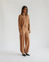 Beige cardigan worn open over a matching top and jogger pants, front view on model.