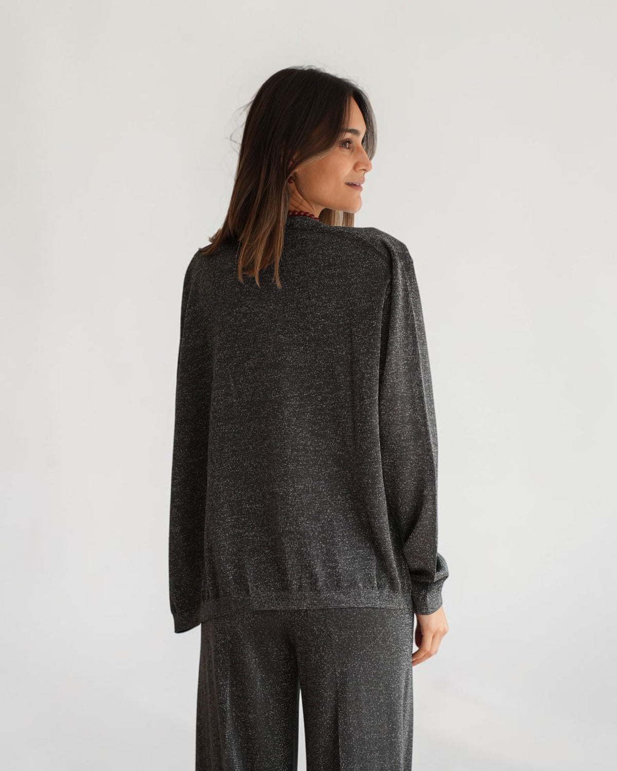 Rückendetail der asymmetrischen Circus Hotel Lamé-Strickjacke in Grau am Model