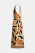 Cream halterneck knit dress with an orange and black leaf pattern, front view.
