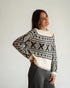 Cream and black Nordic-patterned sweater with a crew neck, front detail on model.