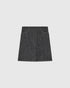 Black and white denim-tweed skirt with contrast stitching and curved front pockets, front view.