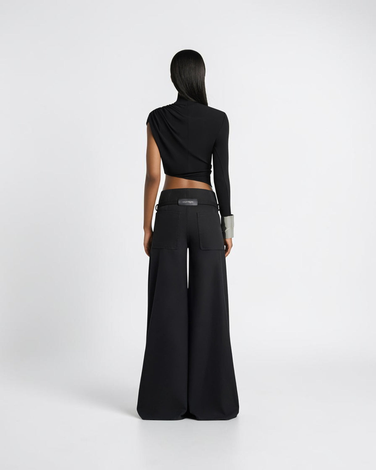 Courrèges black palazzo pants on the model from the back with two patch pockets