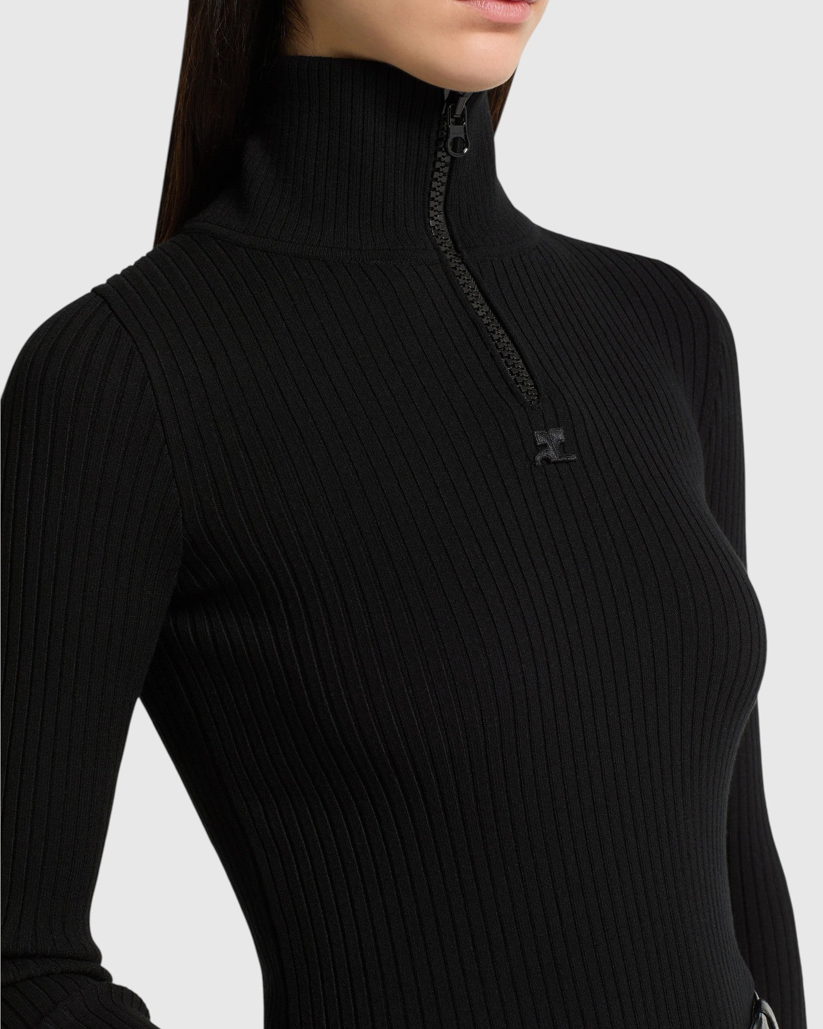 Detail des Courrèges Rippstrick-Pullovers in Schwarz mit Zip-Kragen, Rippstruktur und AC-Logo