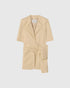 Beige deconstructed blazer with short sleeves and a knotted wrap front, front view.
