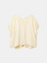 Cream loose-fitting V-neck top with gathered short sleeves and a curved hem, front view.