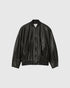 Black oversized leather bomber jacket with a zip front, slanted pockets and ribbed hem, front view.