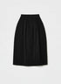 Black midi skirt with deep pleats and a rounded silhouette, front view.