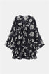 Navy floral blouse with off-white flowers, a ruffled neckline, flared cuffs and a ruffled hem, front view.