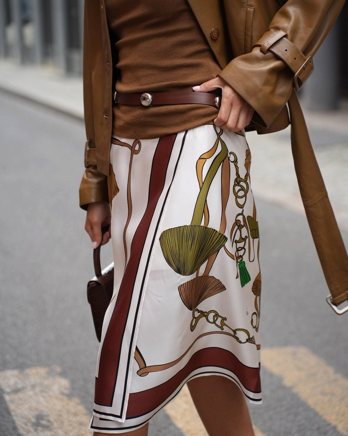 Dorothee Schumacher silk skirt with a mushroom print on a light background, front detail on a model.