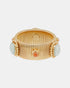 Wide ribbed gold-tone bracelet with pale blue amazonite and orange-red carnelian cabochons, front view.