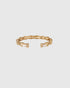 Open gold-tone bamboo-style bangle with clear rectangular rhinestones and ribbed details, front view.