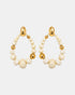 Teardrop earrings with ivory and gold-tone beads and hammered gold-tone studs, shown as a pair.