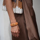 Gas Bijoux Ecume Armband in Orange am Handgelenk