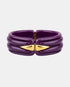 Purple acetate bangle with sculpted ridges and two gold-tone front accents, front view.