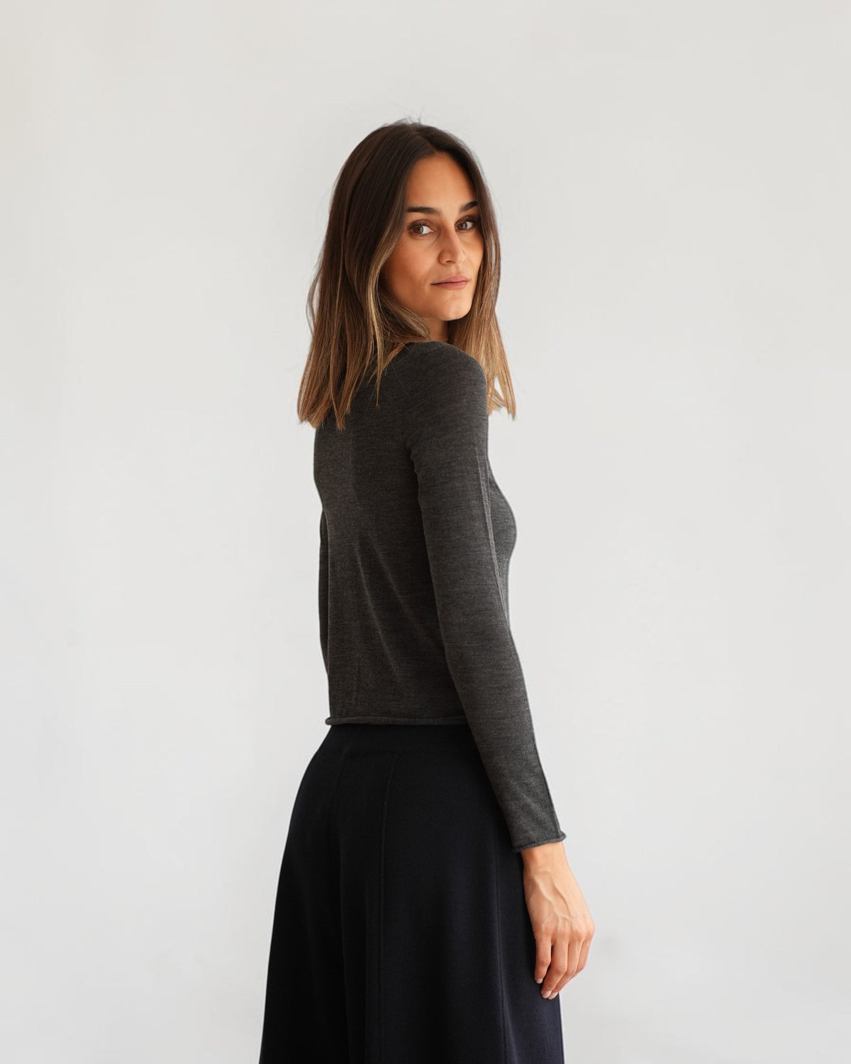 Anthrazitfarbenes Feinstrick-Longsleeve von MRZ, seitliche Rückansicht am Model