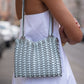 Detail der Rabanne 1969 Flip Bag mit hellblauen 1969 Discs im getragenen Styling