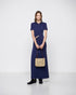 Navy short-sleeved polo maxi dress with a gathered waist and ring-linked cut-out, front view on a model.