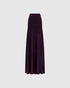 Aubergine knit maxi skirt with a wide fitted waistband and flared lower section, front view.