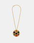Long gold link necklace with a round pendant set with multicoloured faceted stones, laid flat.