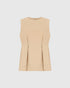 Beige sleeveless top with a round neckline and pleated peplum hem, front view.