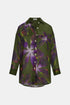 Olive green long-sleeved shirt with a purple floral print, button front and curved hem, front view.