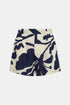 Cream linen shorts with a large navy floral print, front pleats and belt loops, front view.